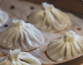 steaming dumplings in a traditional box